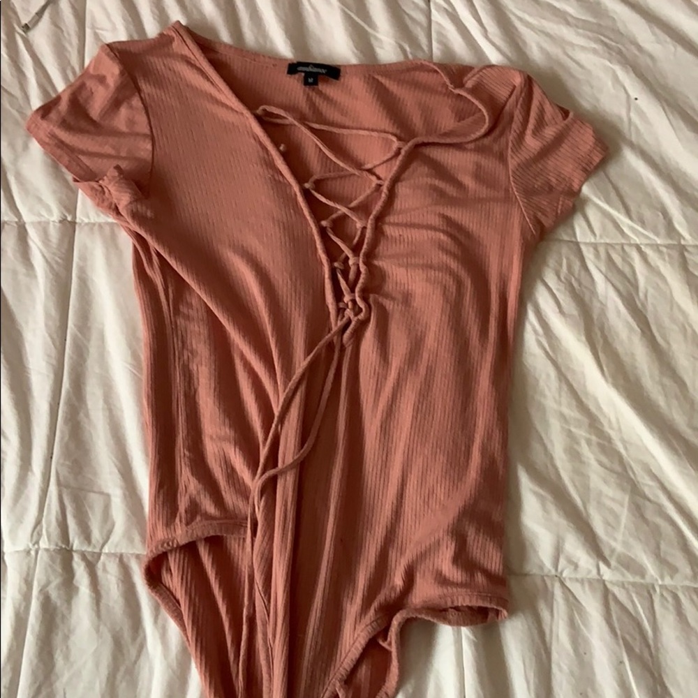 A dark pink colored bodysuit